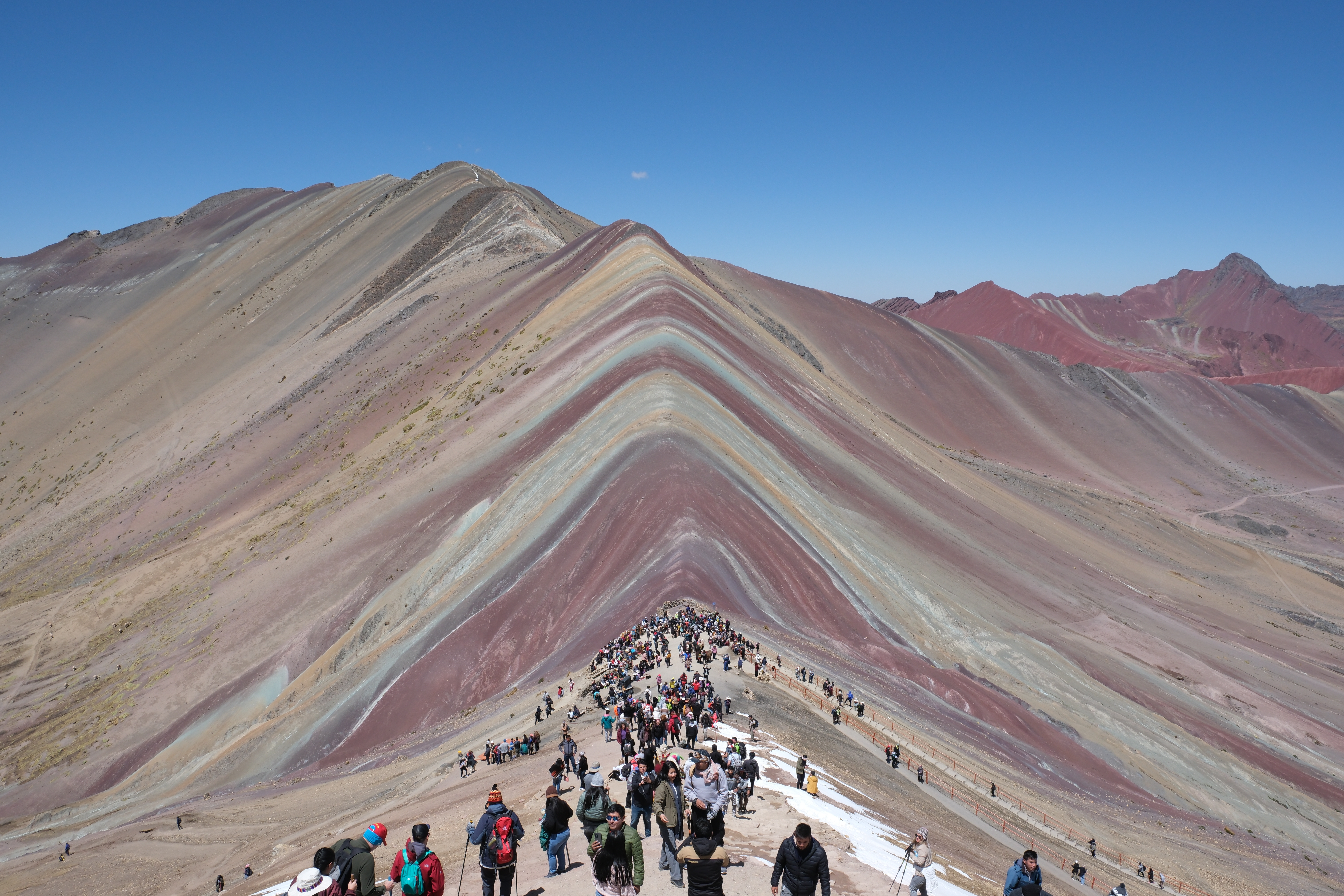 Rainbow Mountain in Peru beneath a clear blue sky